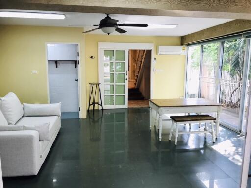 Modern living area with sofa, table, and ceiling fan