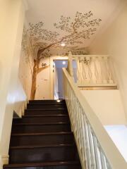 Staircase with decorative tree mural