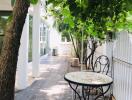 Outdoor seating area with table and chairs under trees