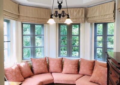 Cozy living room with a corner sofa and large windows