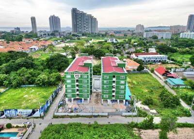 Aerial view of green apartment buildings with red roofs