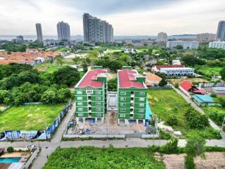 Aerial view of green apartment buildings with red roofs