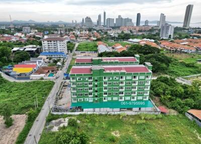 Ariel view of a green apartment building in a residential area