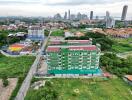 Ariel view of a green apartment building in a residential area