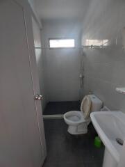 Small bathroom with toilet, sink, and shower