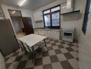 Spacious kitchen with dining table and appliances