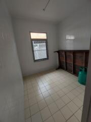 Utility room with tiled floor and single window