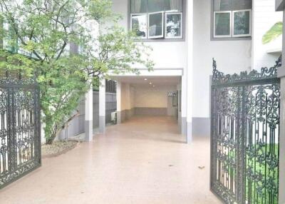 Entrance gate and driveway with covered parking area