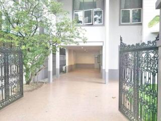 Entrance gate and driveway with covered parking area