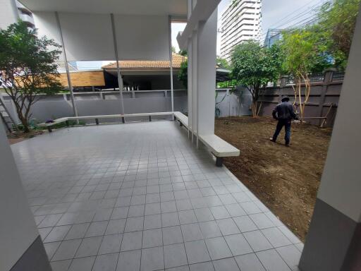 Outdoor patio with tiled flooring and garden area