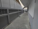 Outdoor corridor with grey fencing and doorways