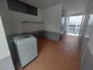 Utility room with a washing machine and storage rack