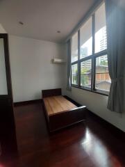 Bedroom with single bed and large windows