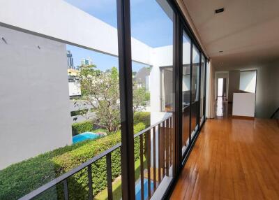 Spacious corridor with large windows and hardwood floors