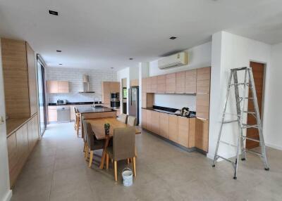 Spacious modern kitchen with dining area and appliances