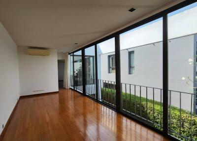 Spacious living room with hardwood floors and large glass windows