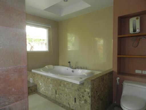 Modern bathroom with a built-in bathtub and a window