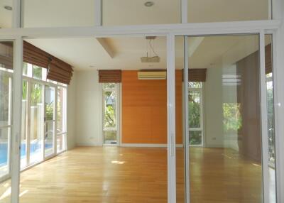 Spacious living room with large windows and wooden floor