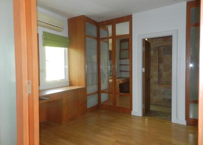 Bedroom with wooden flooring and built-in wooden wardrobes