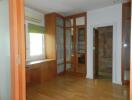 Bedroom with wooden flooring and built-in wooden wardrobes