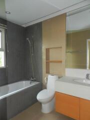 Modern bathroom with bathtub, shower, toilet, and sink with vanity