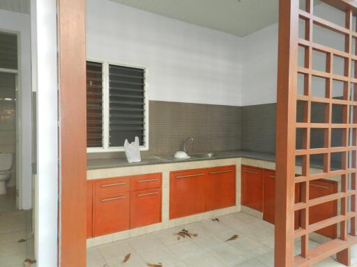 Modern kitchen with red cabinets and granite countertops