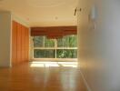 Bright living room with large windows and wooden floor