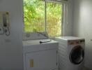 Laundry room with washing machine and dryer