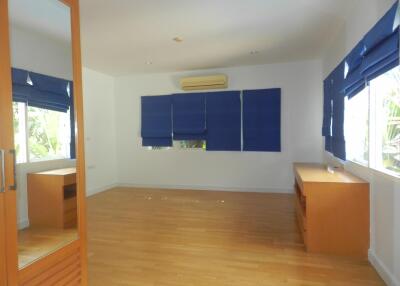 empty bedroom with wooden floor and blue blinds