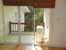 Balcony with glass doors and view of foliage