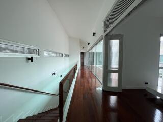 Spacious hallway with hardwood floors and modern design