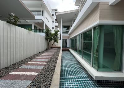 Modern building with adjacent swimming pool and pathway