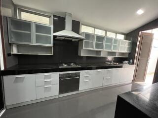 Modern kitchen with black countertops and white cabinets