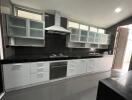 Modern kitchen with black countertops and white cabinets