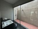 Modern bathroom with large window and exterior shower