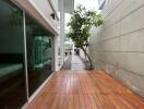 Outdoor walkway with wooden decking and adjacent modern home