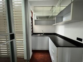 Modern kitchen with black countertops and white cabinets