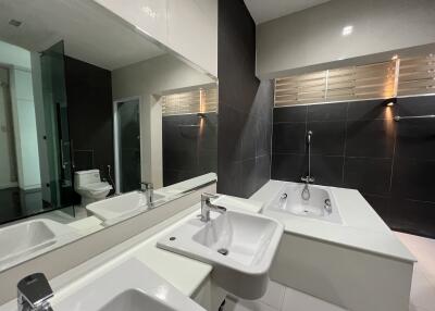 Modern bathroom with bathtub, sink, and toilet