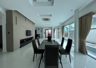 Modern dining area with large windows and black furniture