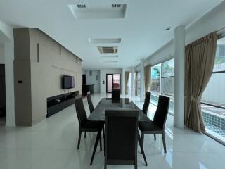 Modern dining area with large windows and black furniture