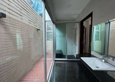 Modern bathroom with glass shower enclosure and large mirror