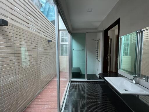 Modern bathroom with glass shower enclosure and large mirror