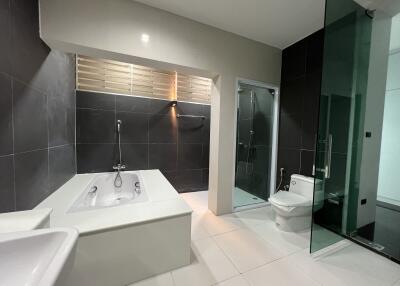 Modern bathroom with bathtub, shower, and toilet