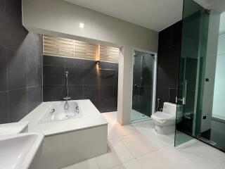 Modern bathroom with bathtub, shower, and toilet