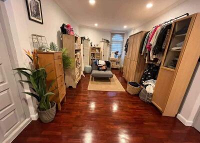 Spacious bedroom with wooden floor and modern furniture