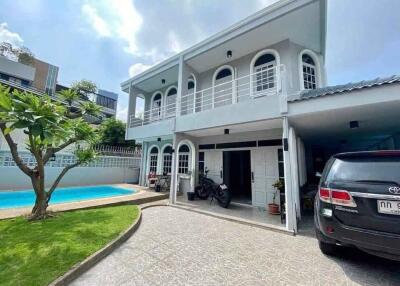 Two-story house with carport and swimming pool