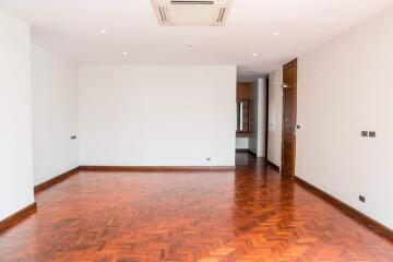 Spacious living room with wooden flooring