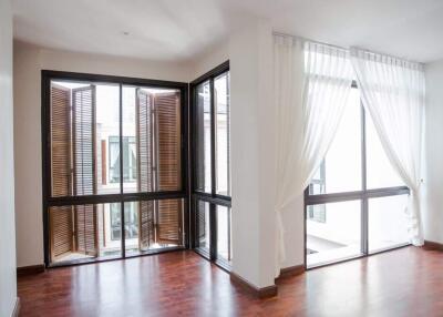 Modern living area with large windows and wooden flooring