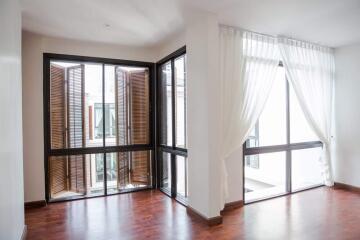 Modern living area with large windows and wooden flooring