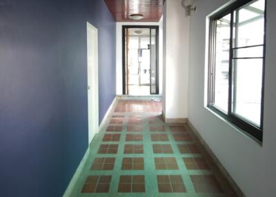 Corridor with tiled flooring and window